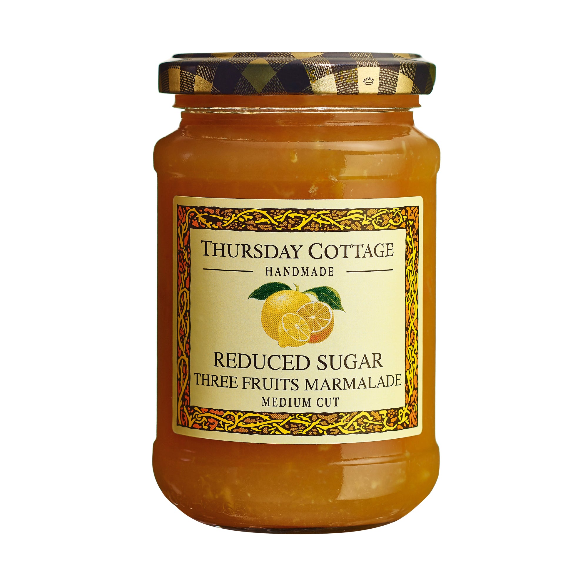 A jar of Thursday Cottage Reduced Sugar Three Fruits Marmalade with a label showing the brand name and a picture of a lemon, a grapefruit and an orange. The jar is sealed with a black and gold patterned lid.