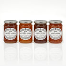 Four jars of Tiptree orange marmalade on a white background