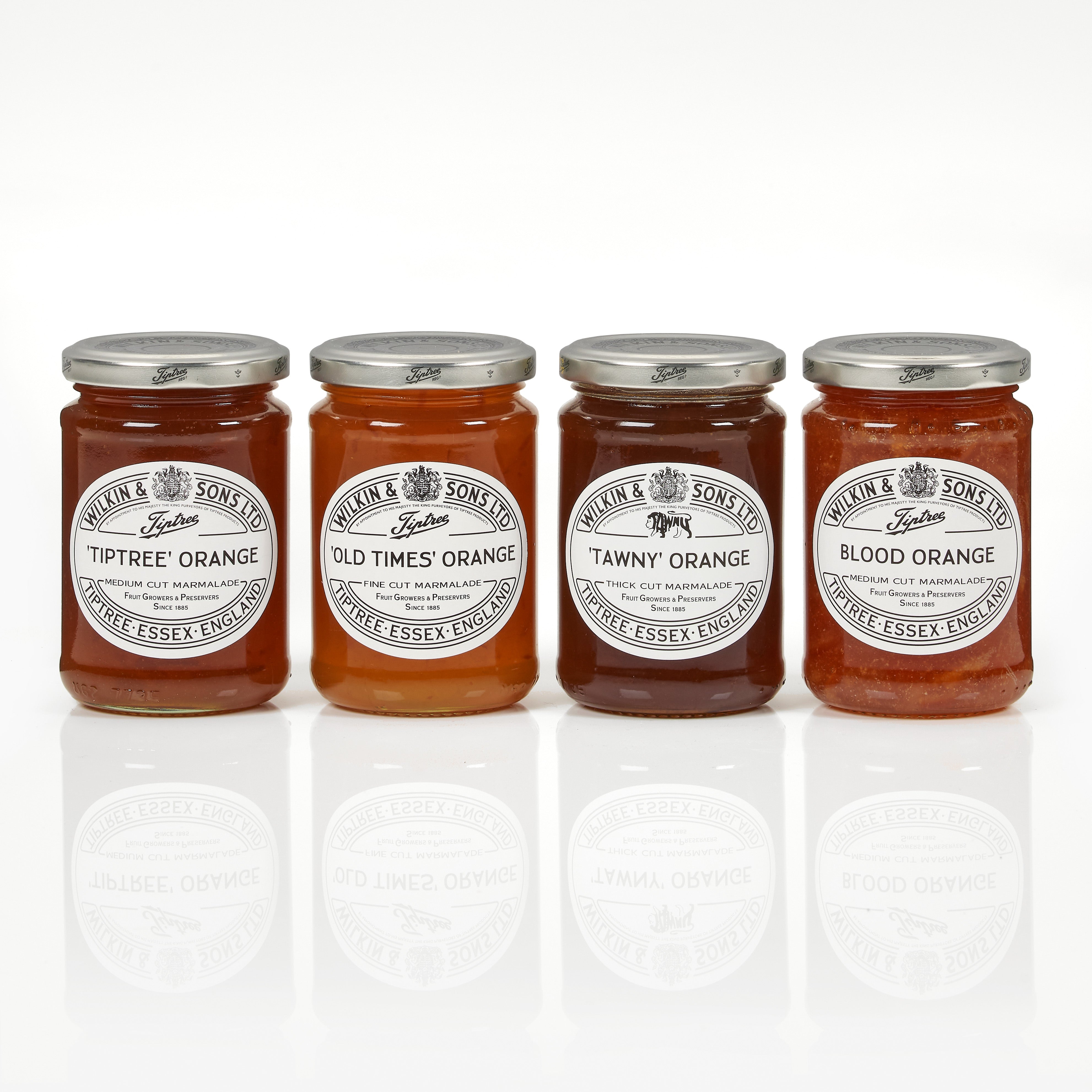 Four jars of Tiptree orange marmalade on a white background