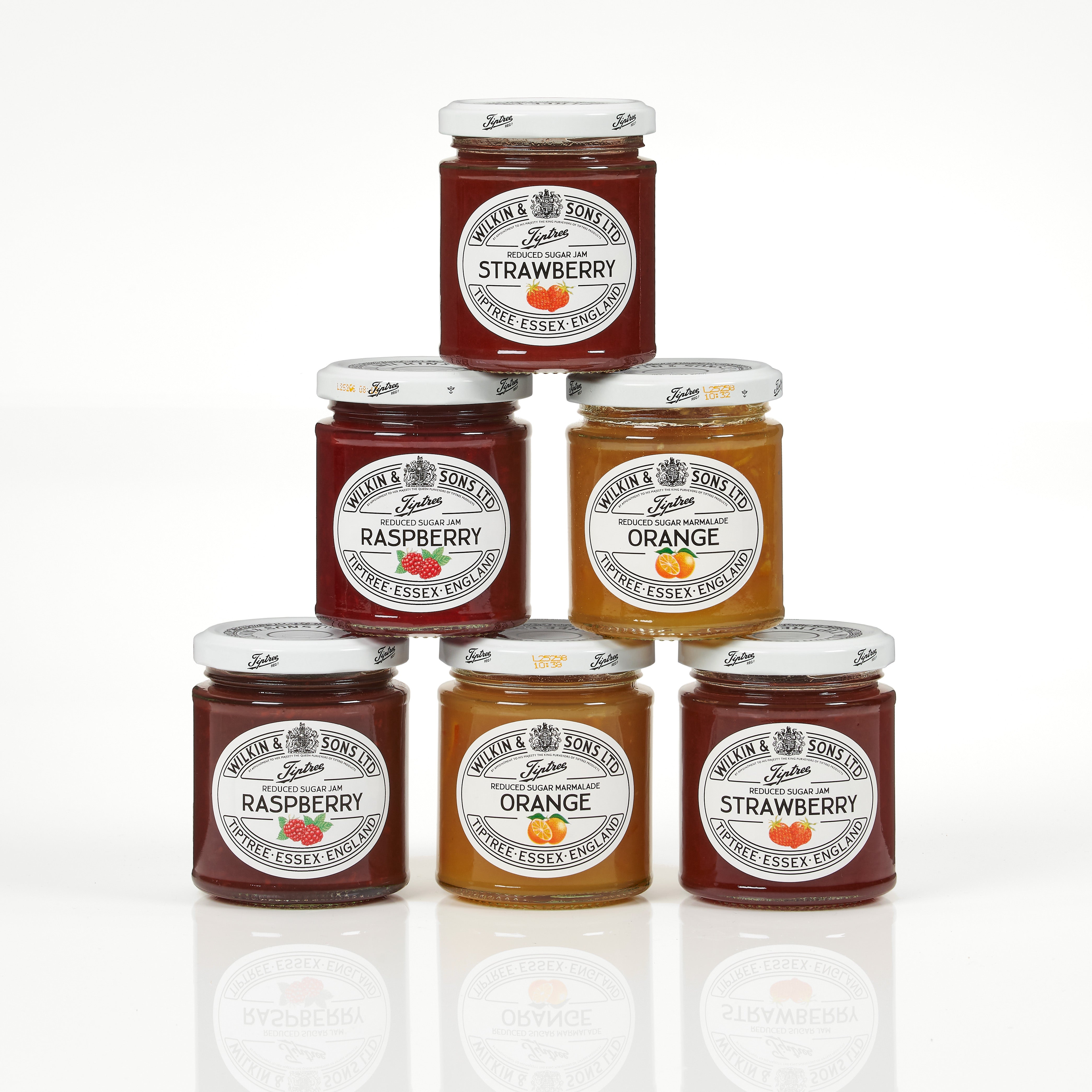 Stack of jam jars with different flavors on a white background