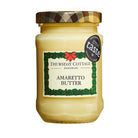 A jar of Thursday Cottage Amaretto Butter with a Christmas-themed label, indicating that it is a creamy dessert spread with amaretto flavor.